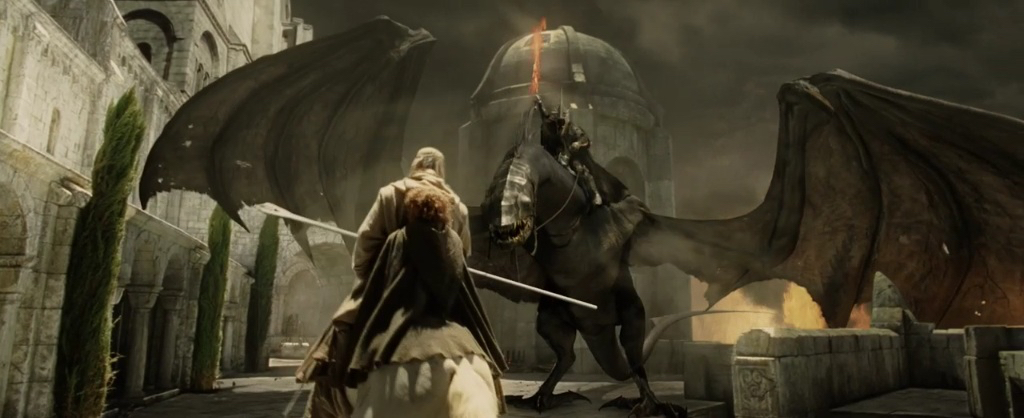 A frame from The Return of the King with Gandalf and Pippin from behind, facing the Witch-king with a flaming sword pointed to the sky